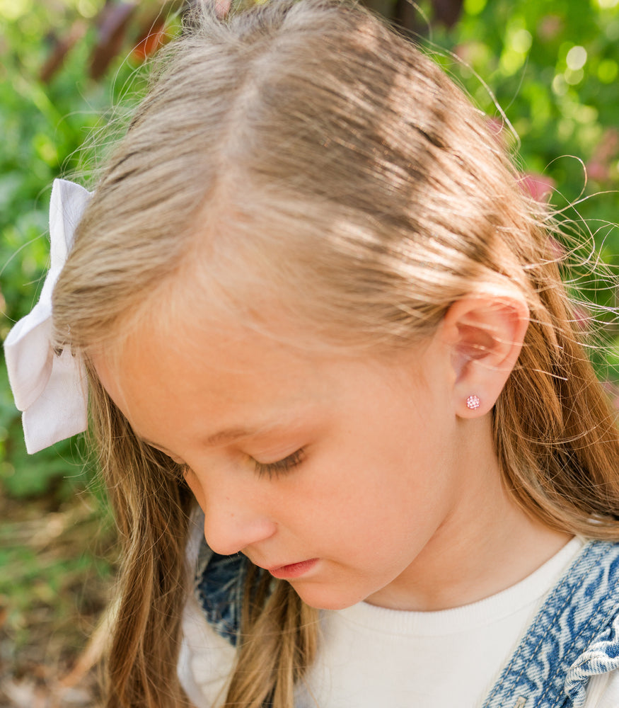 girl wears hypoallergenic earrings for kids