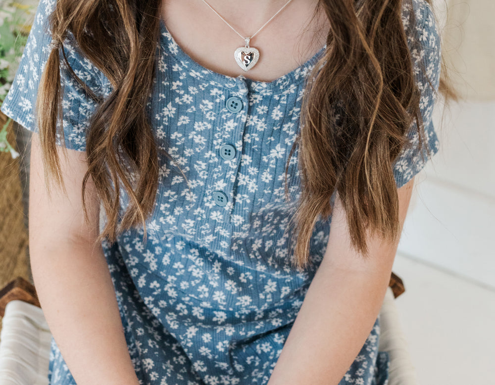 Closeup of girl wearing Sterling Silver Children's Personalized Heart Locket with CZ Stones