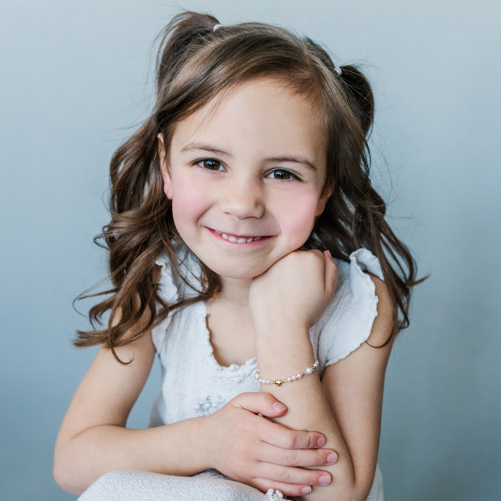 girl wearing 14K Gold-Plated Pink and White Pearl Heart Bracelet