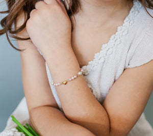 little girl wearing 14K Gold-Plated Pink and White Pearl Heart Bracelet