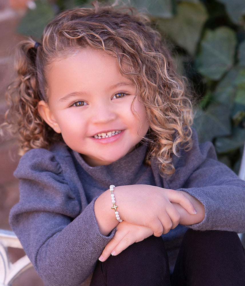 Toddler wearing Cross Bracelet First Communion Gift