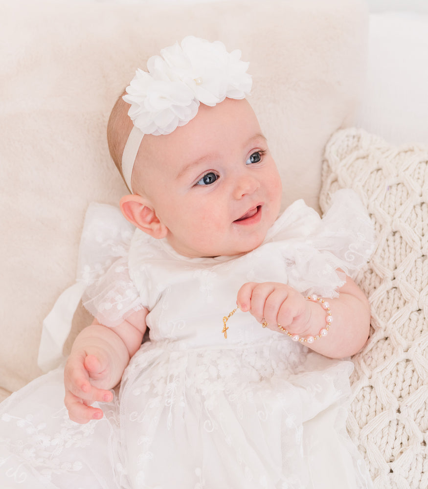 Baby wearing 14K Gold-Plated Pink Baby Rosary Baptism Gift