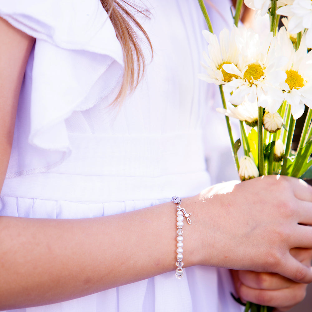 Girl wearing baptism to bride baptism bracelet