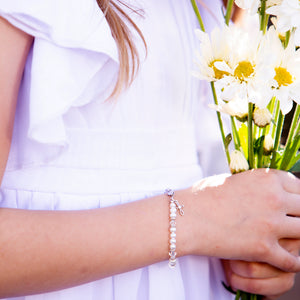 Girl wearing baptism to bride baptism bracelet